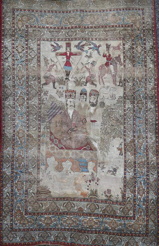 A 19th century Persian ivory ground pictorial rug, depicting a Shah, 6ft 9in by 4ft 7in.